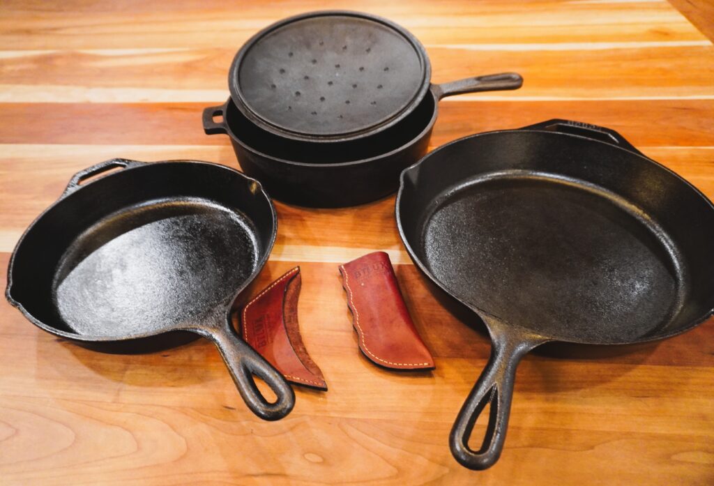 three pieces of cast iron with accessories on a counter