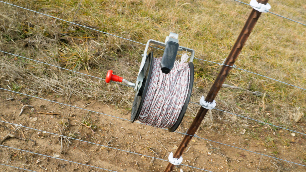 reel of poly wire on a fence