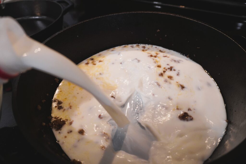 pouring milk into a cast iron skillet