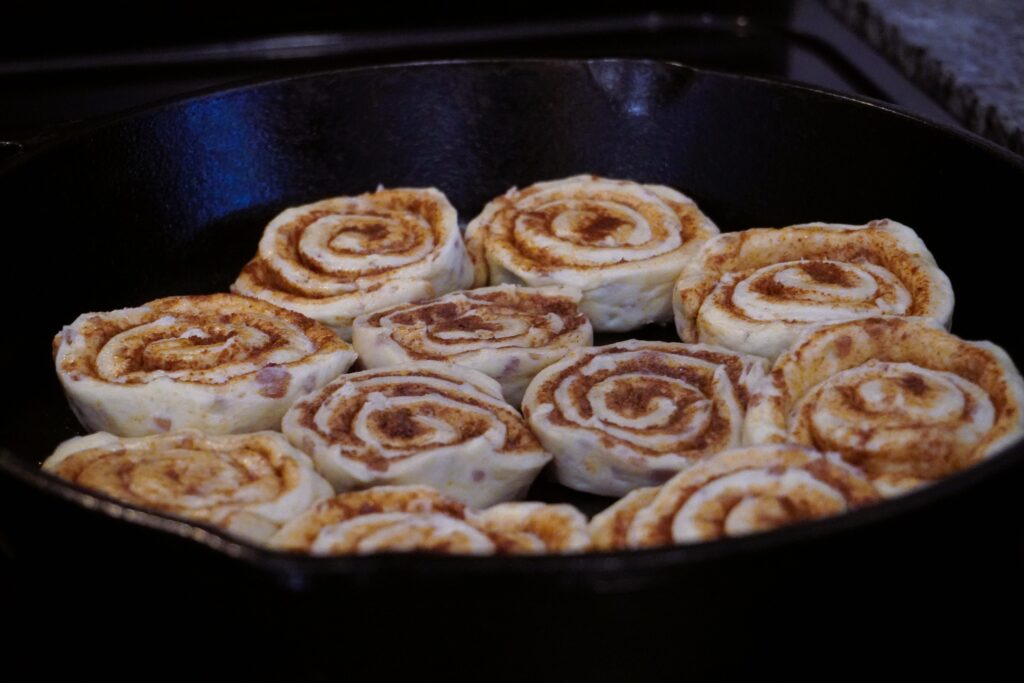 uncooked cinnamon rolls in a cast iron skillet