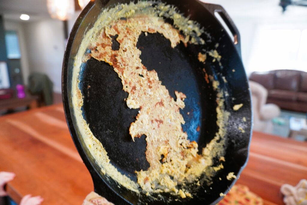 left over eggs mess in a cast iron skillet