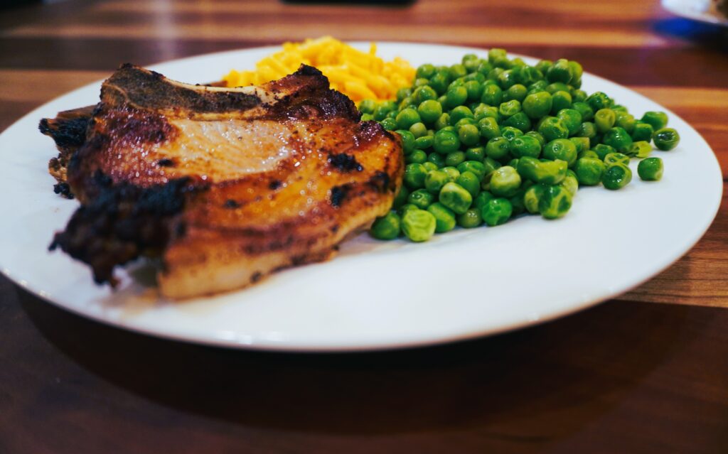 pork chop dinner with peas and macaroni and cheese