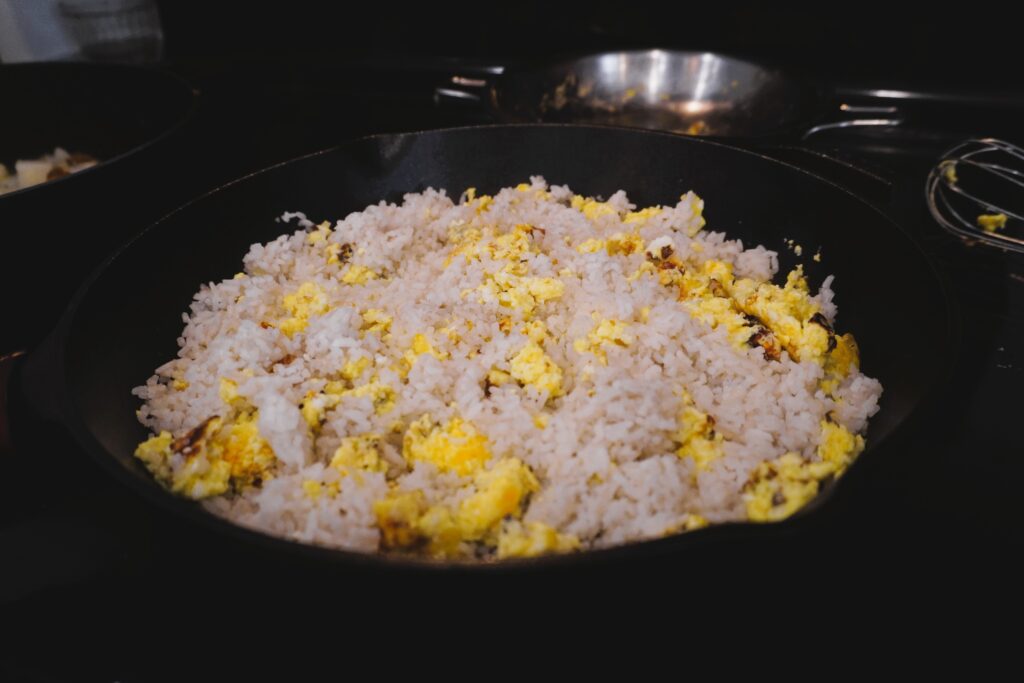 Eggs and rice cooking in a skillet