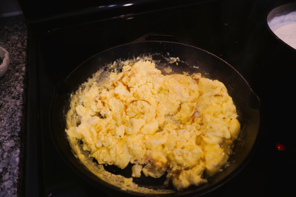 cooked scrambled eggs in a cast iron skillet