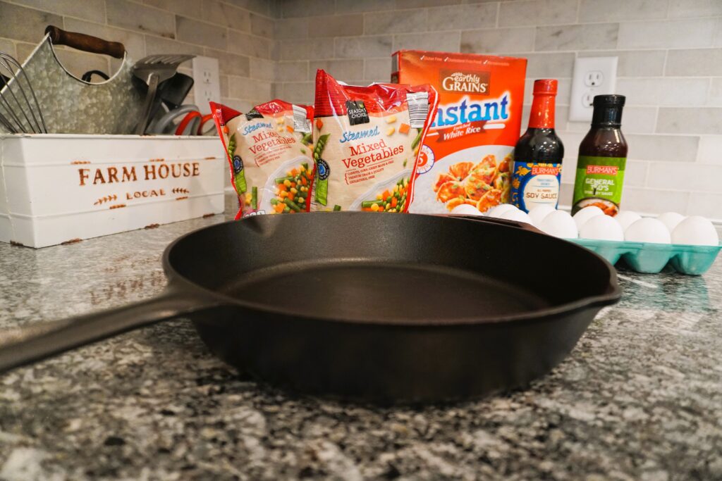 empty cast iron skillets and ingredients on a countertop