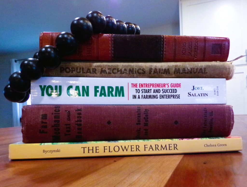A stack of books for farmers on a counter