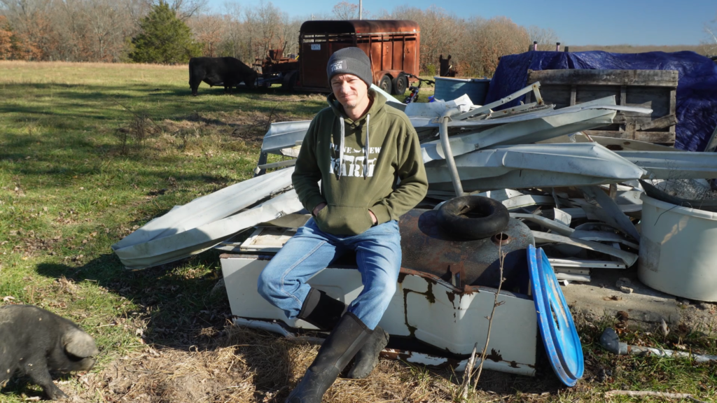 Man sitting on a pile of junk