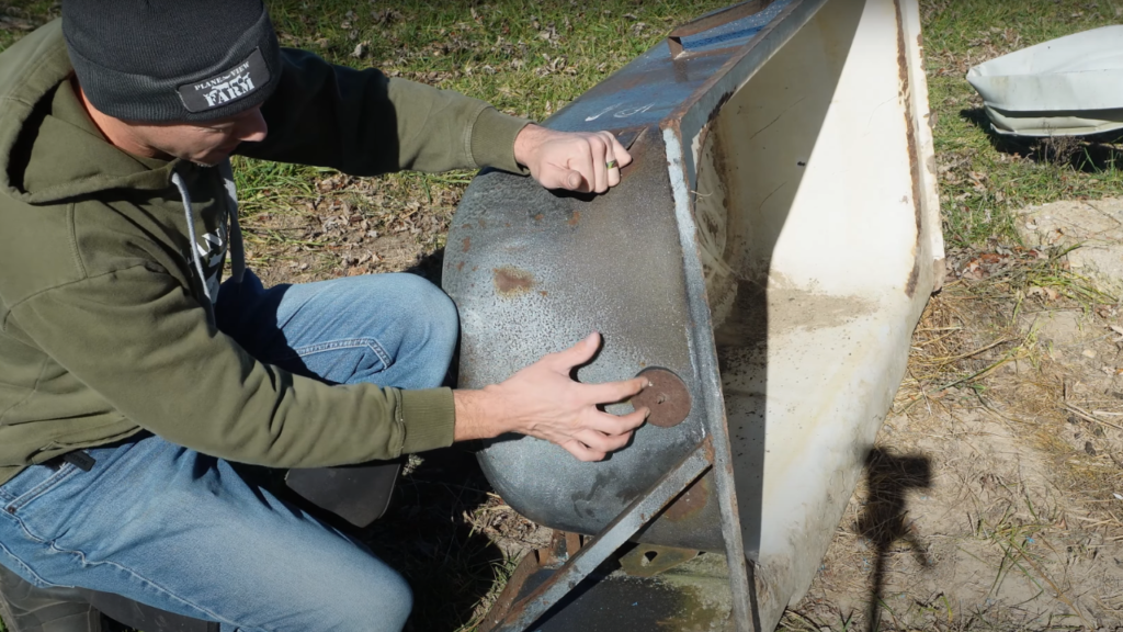 Man looking at an old bathtub