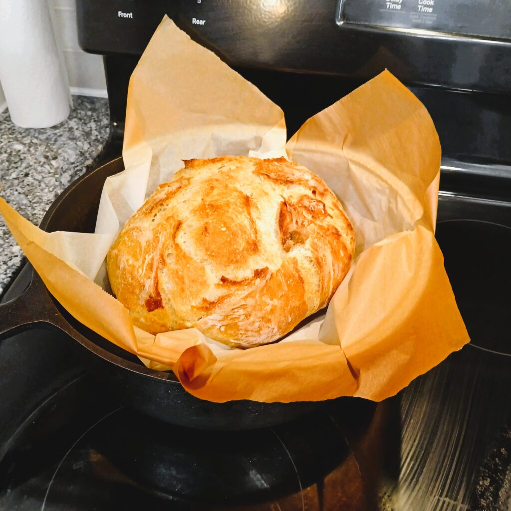 Baked Artisan Bread in a cast iron skillet on a oven