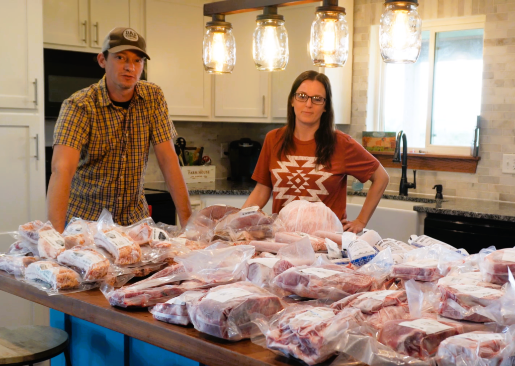 Man and women in a kitchen with processed pork on a counter