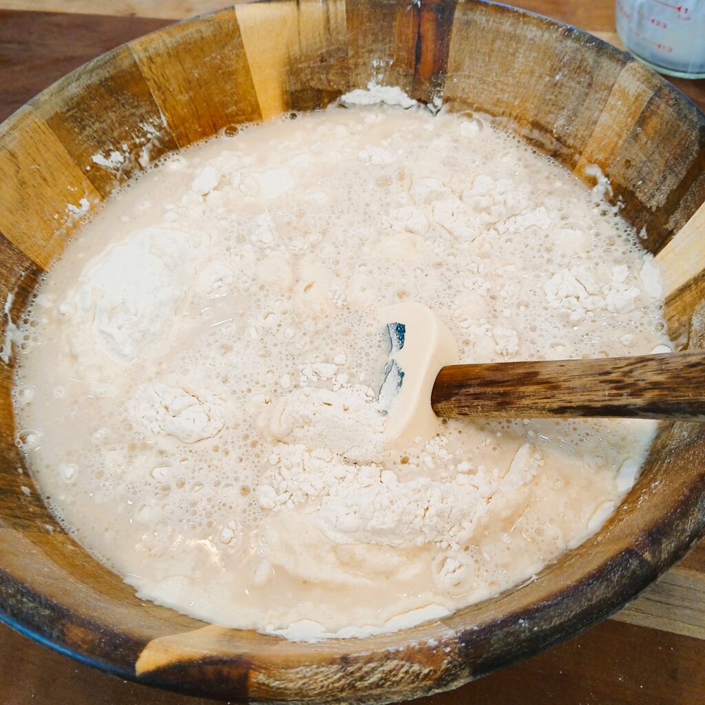 Sandwich bread mixture in a wooden bowl