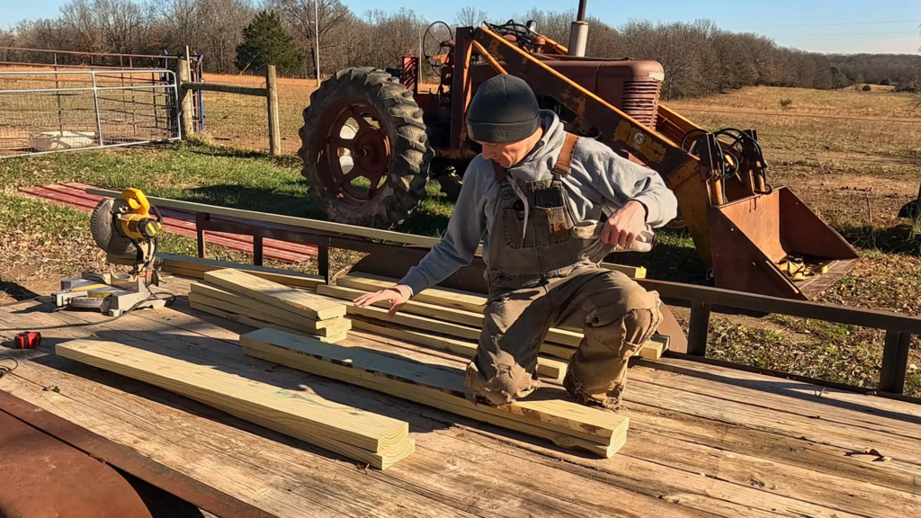 Man with 2 x 4s on a trailer