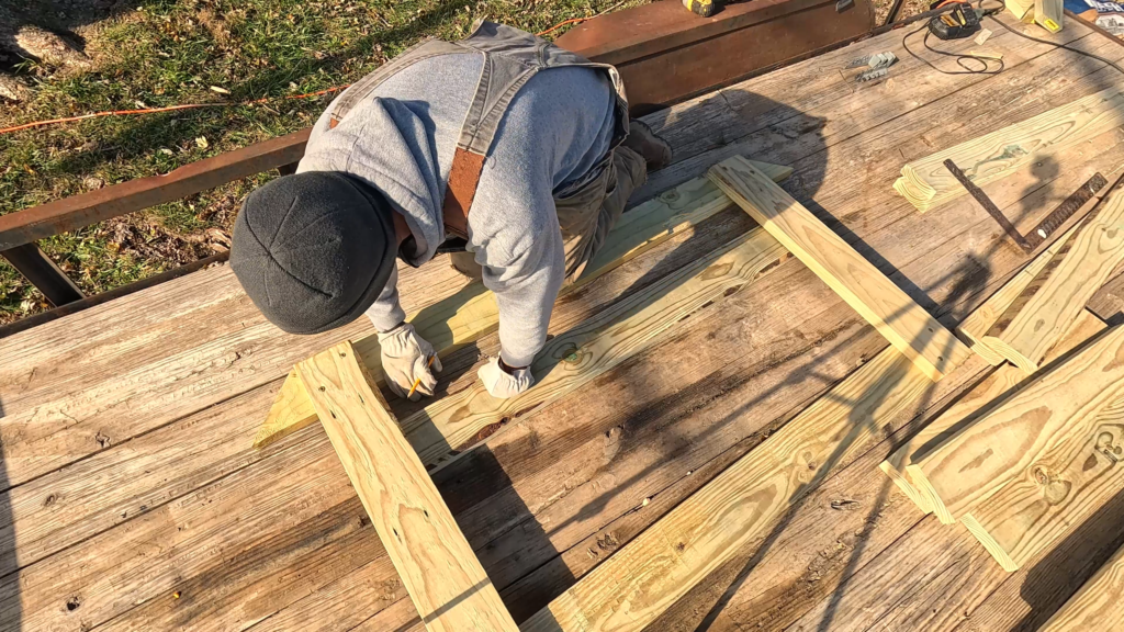 Man making a cut mark on a board