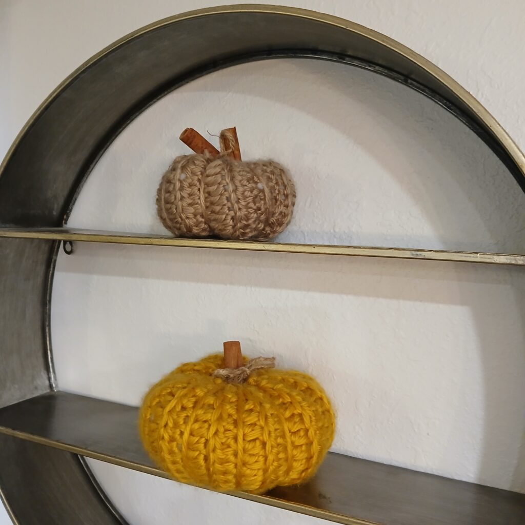 Crochet pumpkins on a shelf