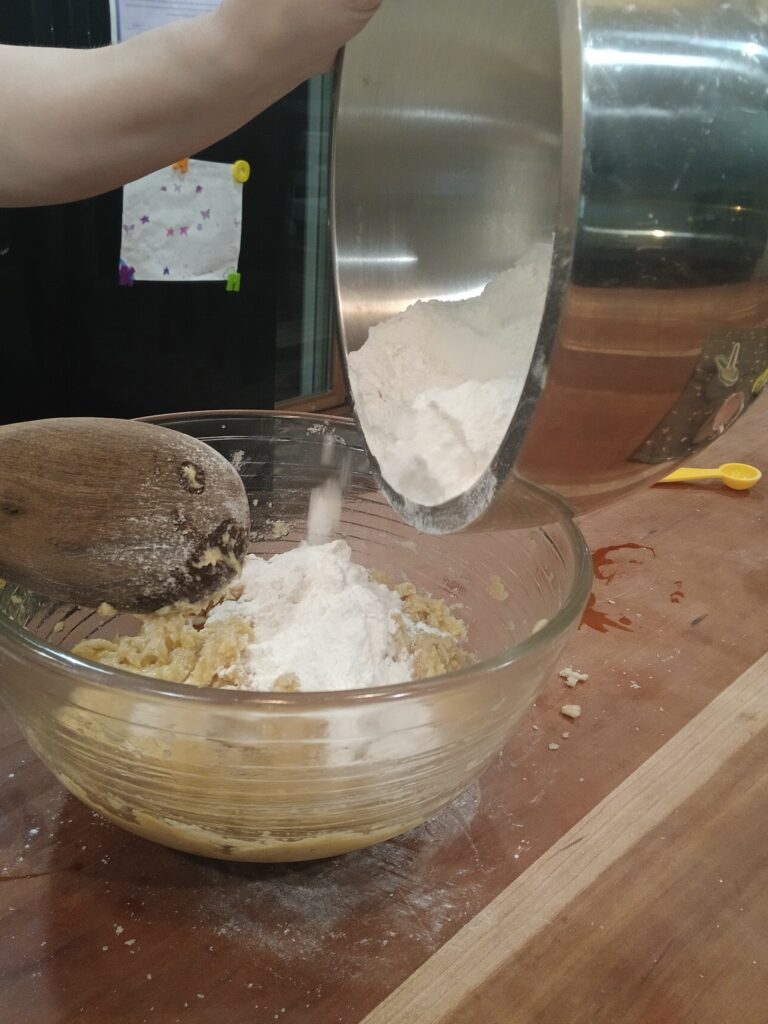 Adding flour to bowl