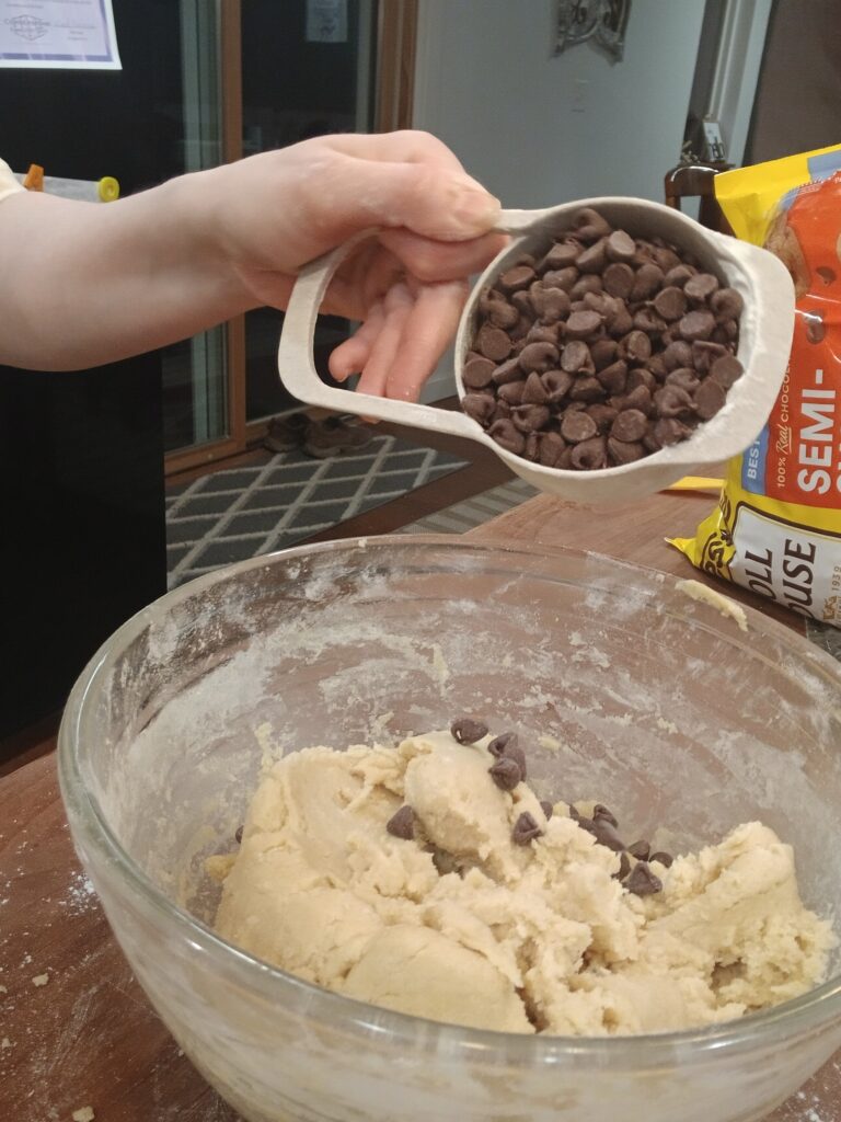 Adding chocolate chips to dough