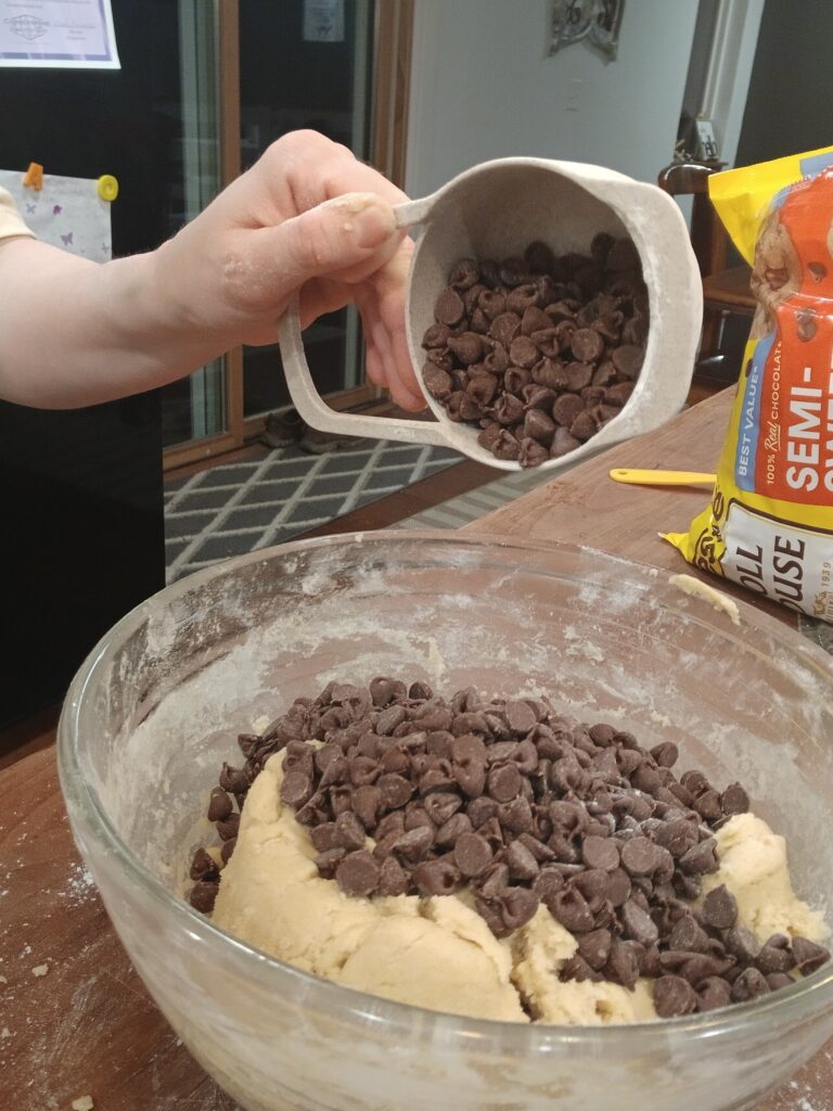 Adding chocolate chips to dough