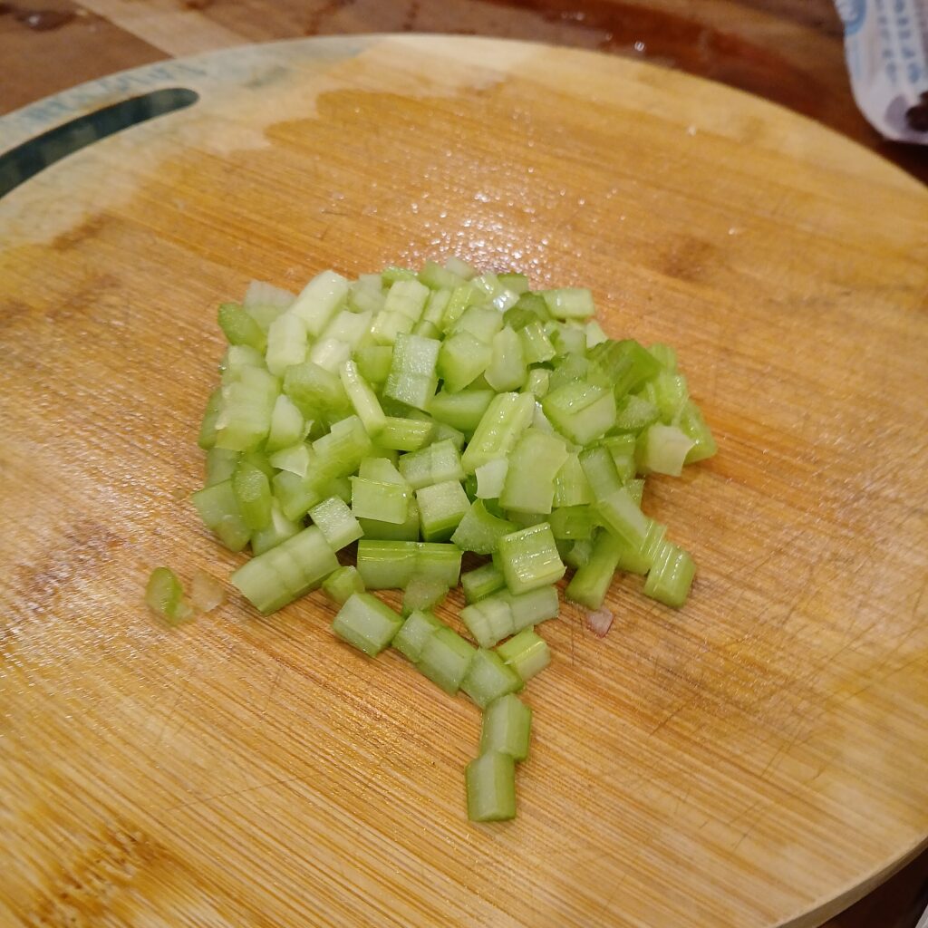 Cut up celery on a cutting board