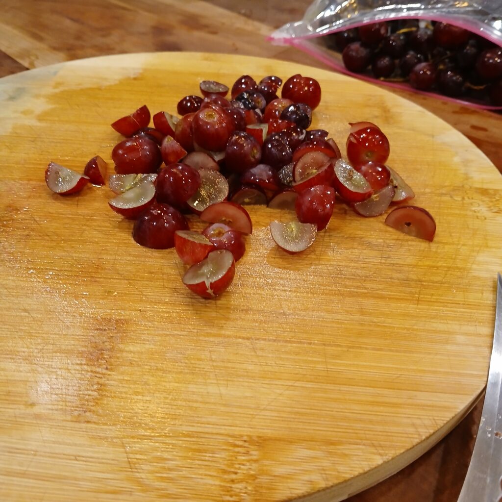 Cut up grapes on a cutting board