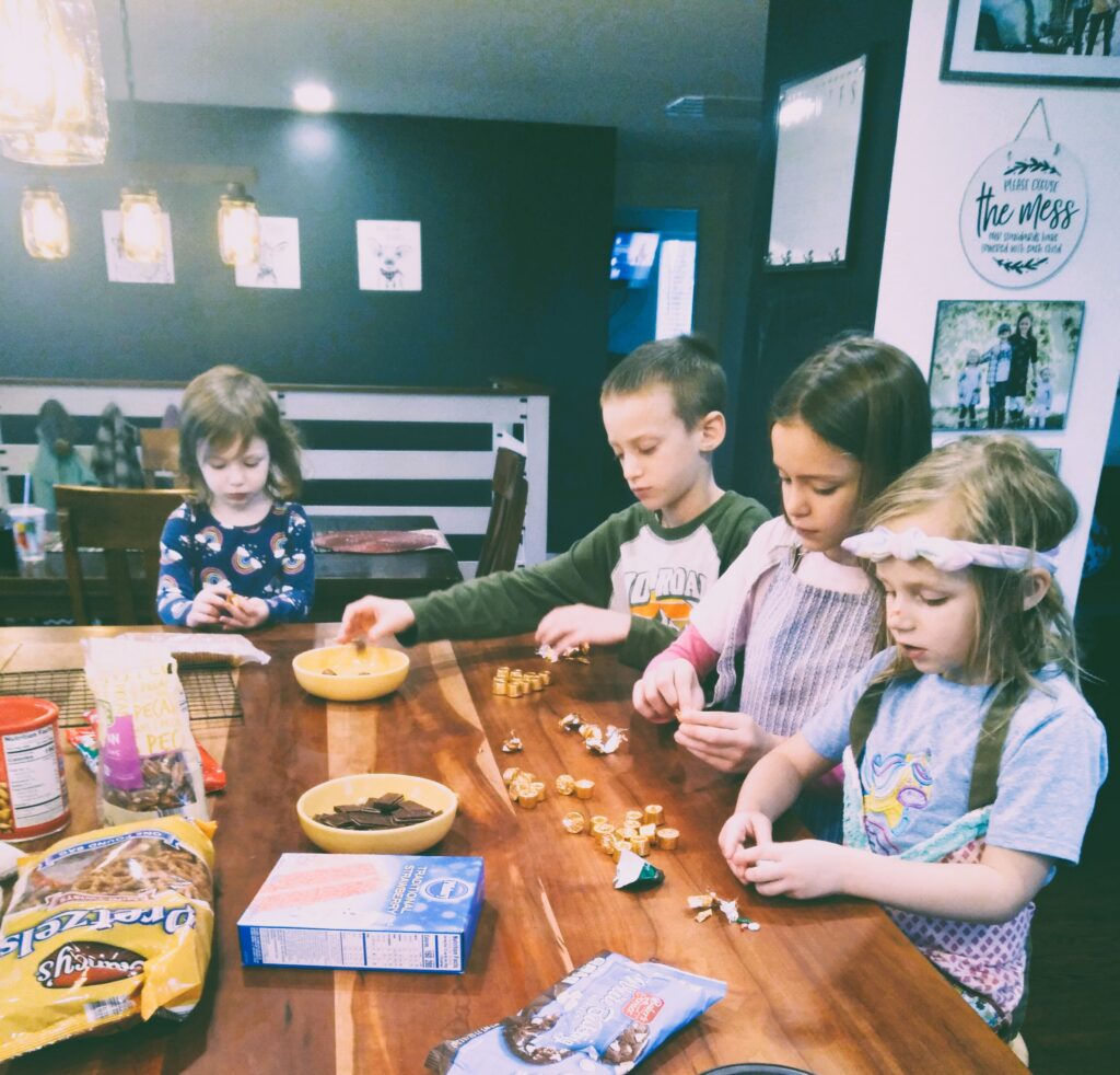 Four children at a counter baking